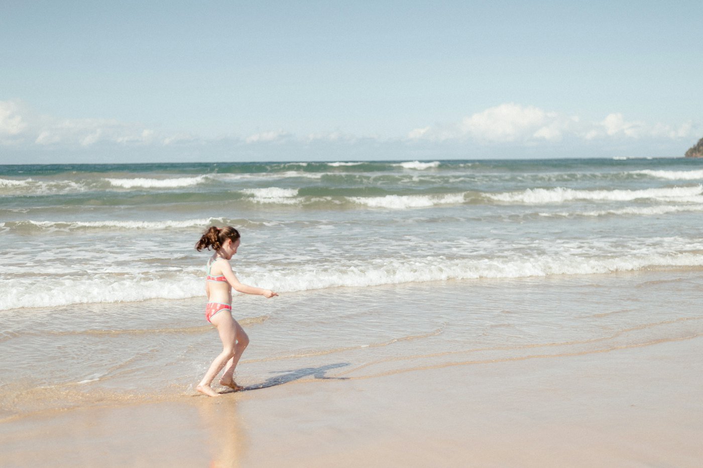 A girl running through the shallows