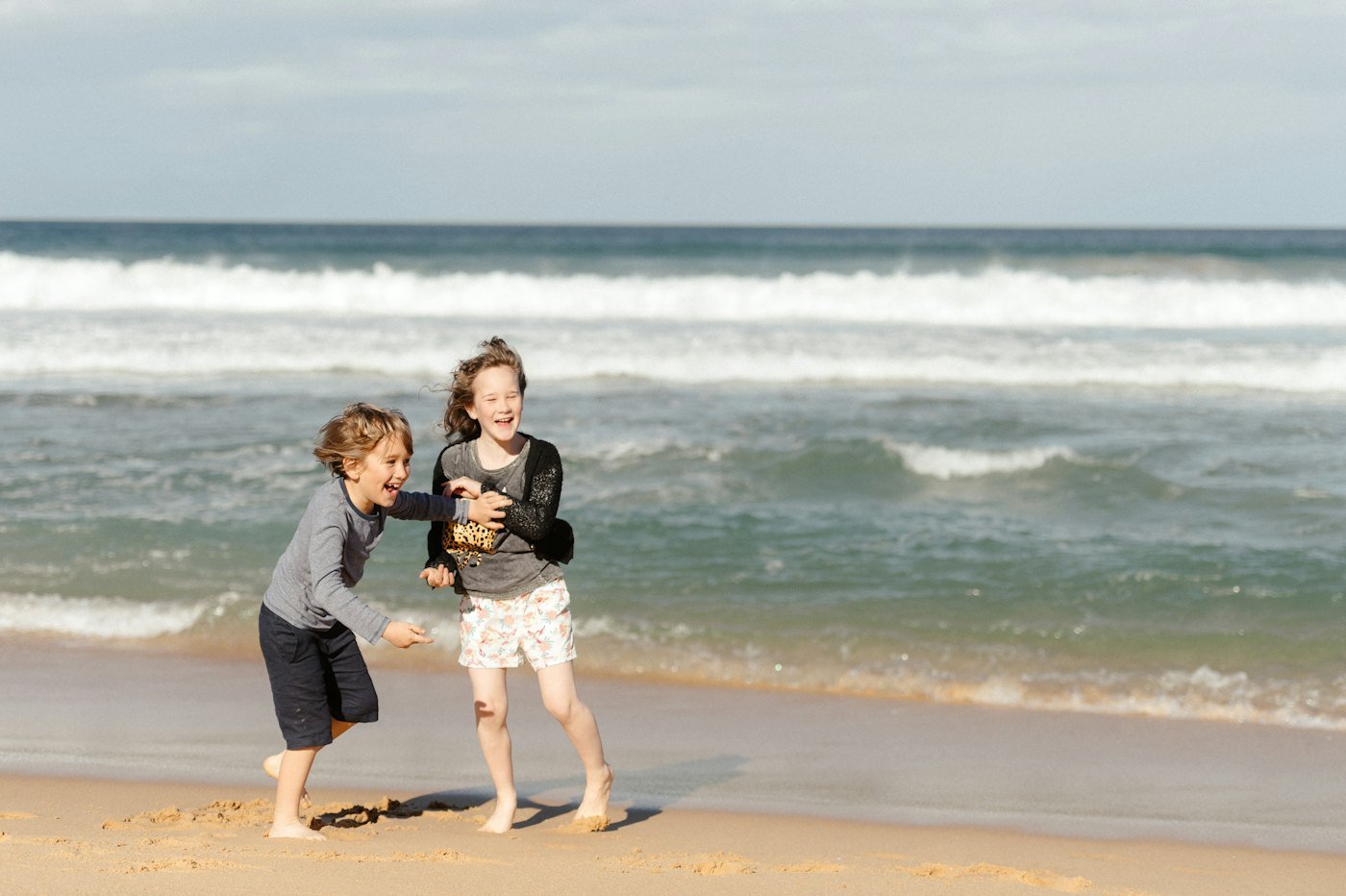 Two brothers dancing in the waves