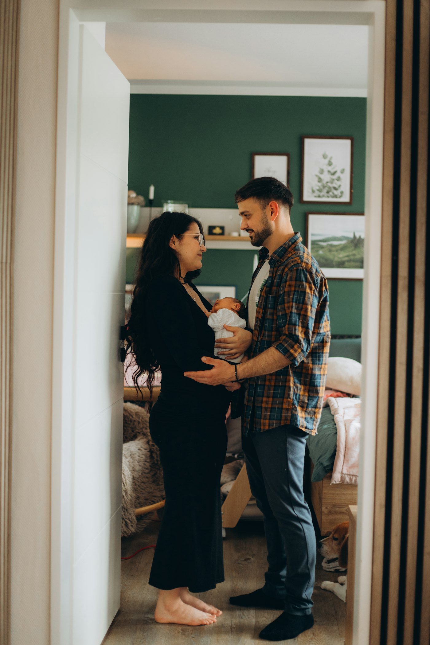 Expecting parents embracing in their home
