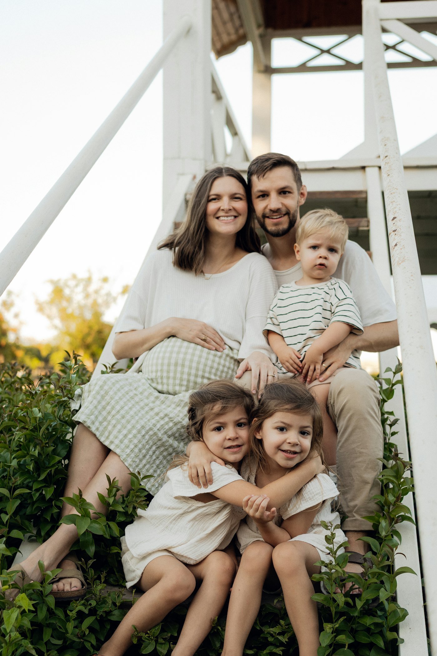 A pregnant mother with her partner and three children